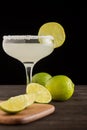 Close-up of limes and lemons and margarita cocktail, selective focus, black background, Royalty Free Stock Photo