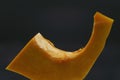 close-up of the lines of a piece of pumpkin on a black background