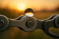 Close-up on the link of a bicycle chain perfectly clean and oiled with a single dewdrop. Royalty Free Stock Photo