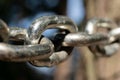 Close-up of the links of a metal chain in sunlight; selective focus; strength and connection; bond