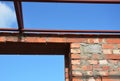 Close up on lintel. Window metal lintel on brick unfinished house construction. Royalty Free Stock Photo