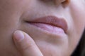 close up lips of mature female face, woman 50 years old carefully examines wrinkles around mouth, skin defects, facial hair, age-