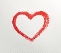 Close up of lipstick heart shape on white background.