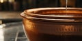 Close up of liquid pouring into a copper pot with a blurred background in a kitchen setting indoors Royalty Free Stock Photo