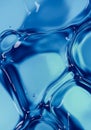 A close-up of a liquid surface with a smooth, glass-like texture in varying shades of blue Royalty Free Stock Photo