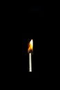 Close Up of Lit Match Suspended in the Air with a Black Background Royalty Free Stock Photo