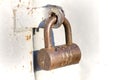 Close-up of lit by sun old rough metal padlock on garage or barn iron gate. Outdated technology, safety, security and protection Royalty Free Stock Photo