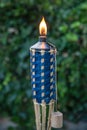 Close up of lit Tiki torch before a backyard party.