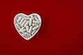 Close-up of lithium orotate capsules. dietary concept: an porcelain bowl in the form of a heart full of lithium orotate capsules.