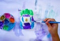 Little asian child girl right hands painting color on the plaster car statue with bright blue paintbrush and colorful watercolor Royalty Free Stock Photo