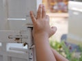 Little baby`s hands learning to push / open front gat Royalty Free Stock Photo