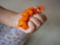 Close up of little baby`s hands squeezing playdough