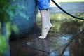 Close up of a little boy's feet on tip toes watering the garden Royalty Free Stock Photo