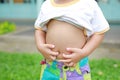 Close up little boy with stomach ache, child holding hands on his belly Royalty Free Stock Photo