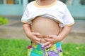 Close up little boy with stomach ache, child holding hands on his belly Royalty Free Stock Photo