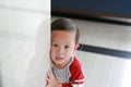 Close up little caucasian boy hide behind a corner room. Small children playing peekaboo game indoor. What a surprise Royalty Free Stock Photo