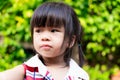 Close Up of little child face is looking at something wondering from her side. Cute girl cut the bangs.