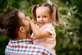 Close-up of little cute girl smiling in the arms of her father. Royalty Free Stock Photo