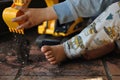 CLOSE UP LITTLE DIRTY BOY PLAYING WITH TOY DIGGER AT HOME WITH