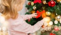 Close up of little girl decorating christmas tree Royalty Free Stock Photo