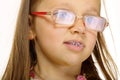 Close up little girl in glasses doing fun saliva bubbles Royalty Free Stock Photo