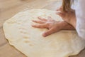 Close up of little girl hand on a dough on a table