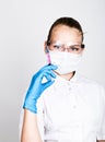 Close-up little girl in a medical dress and gloves holding a syringe Royalty Free Stock Photo