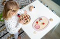 Close up of little girl playing with wooden toy giraffe Royalty Free Stock Photo