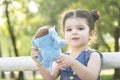 Close up Little girl portrait holding a blue elephant doll in hands Royalty Free Stock Photo