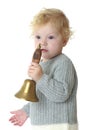 Close-up of a little girl rings the bell