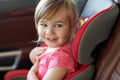 Close up of little girl sitting in baby car seat Royalty Free Stock Photo