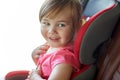 Close up of little girl sitting in baby car seat Royalty Free Stock Photo