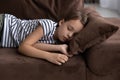 Close up little girl taking day nap, sleeping on couch Royalty Free Stock Photo