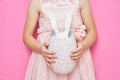 Close-up of a little girl, unrecognizable, holding out a large souvenir in the form of an eggshell, from which white