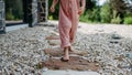 Close up of little girl walking barefoot near the forest cotage,weekend time during summer day. Royalty Free Stock Photo