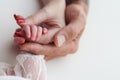 The newborn baby has a firm grip on the parent& x27;s finger after birth.