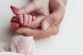 The newborn baby has a firm grip on the parent& x27;s finger after birth.