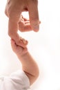 Close-up little hand of child and palm of mother and father. A newborn holds on to mom& x27;s, dad& x27;s finger. Royalty Free Stock Photo