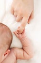 Close-up little hand of child and palm of mother. A newborn holds on to mom's finger. Royalty Free Stock Photo