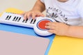 Close up little hands plays on a toy piano. Royalty Free Stock Photo