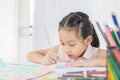 Little kid girl drawing with colorful pencils Royalty Free Stock Photo