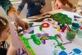 Close-up of little kids working on project with teacher during creative art and craft class at school Royalty Free Stock Photo