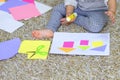 Close up little preschooler toddler girl gluing colorful paper. Royalty Free Stock Photo