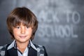 Close-up of little school boy near blackboard Royalty Free Stock Photo