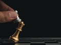 Close-up little silver pawn piece checkmates the golden king on chessboard. Royalty Free Stock Photo