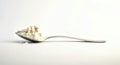 Close up little spoon full of flour on white background. Side view.