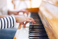 Close up of a little student`s hands is playing piano Royalty Free Stock Photo