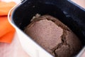 Close-up of a loaf of black Borodino bread in an electric bread maker. Aromatic homemade cakes