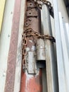 Lock on a chain on a rusty metal container Royalty Free Stock Photo