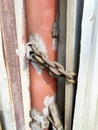 Lock on a chain on a rusty metal container Royalty Free Stock Photo